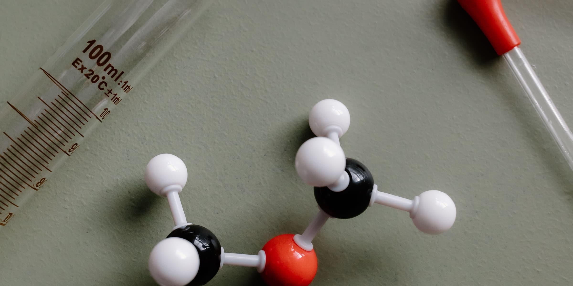 Molecular model beside a pipette and measuring cylinder