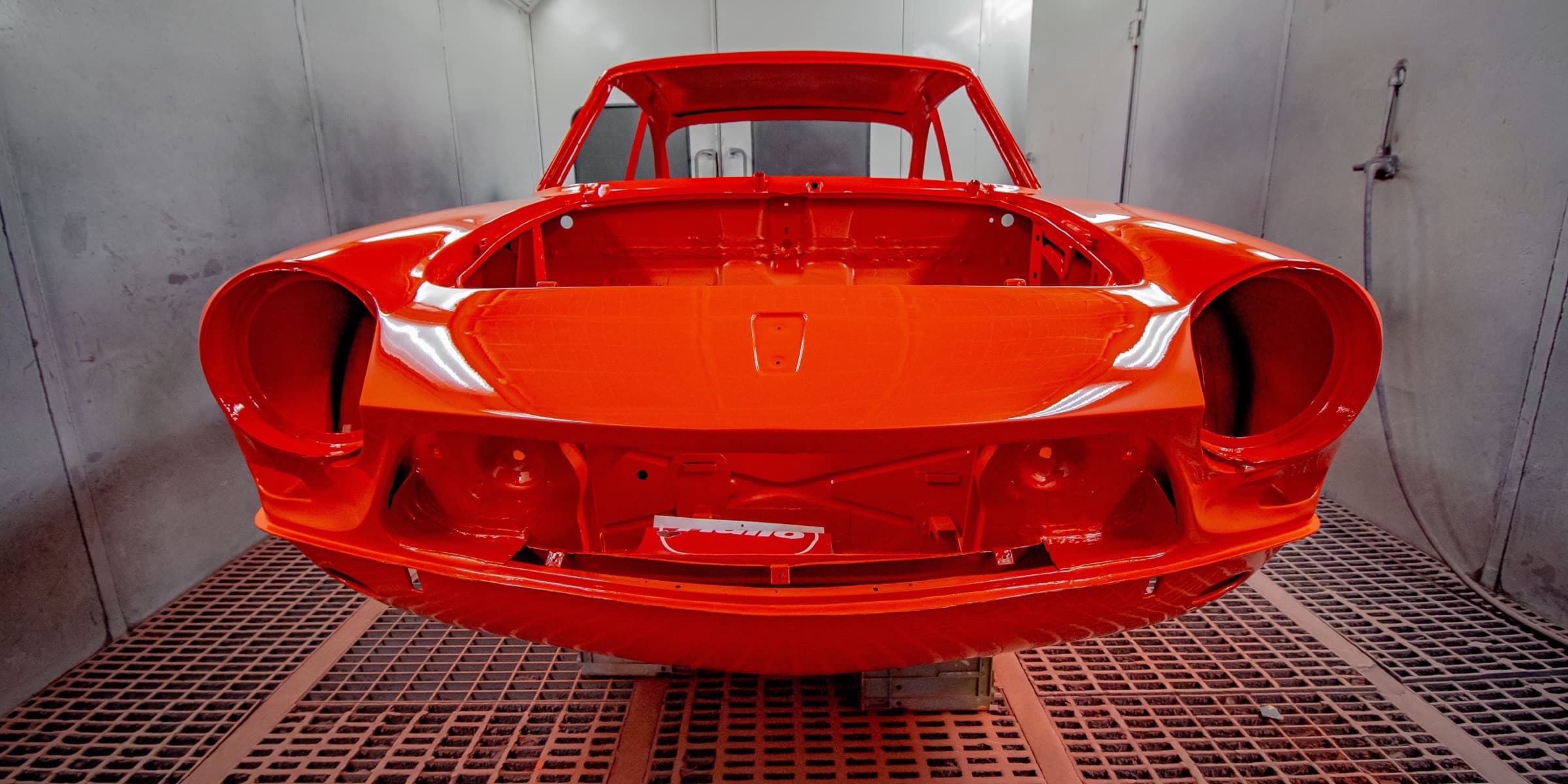 Painted car body in a spray booth