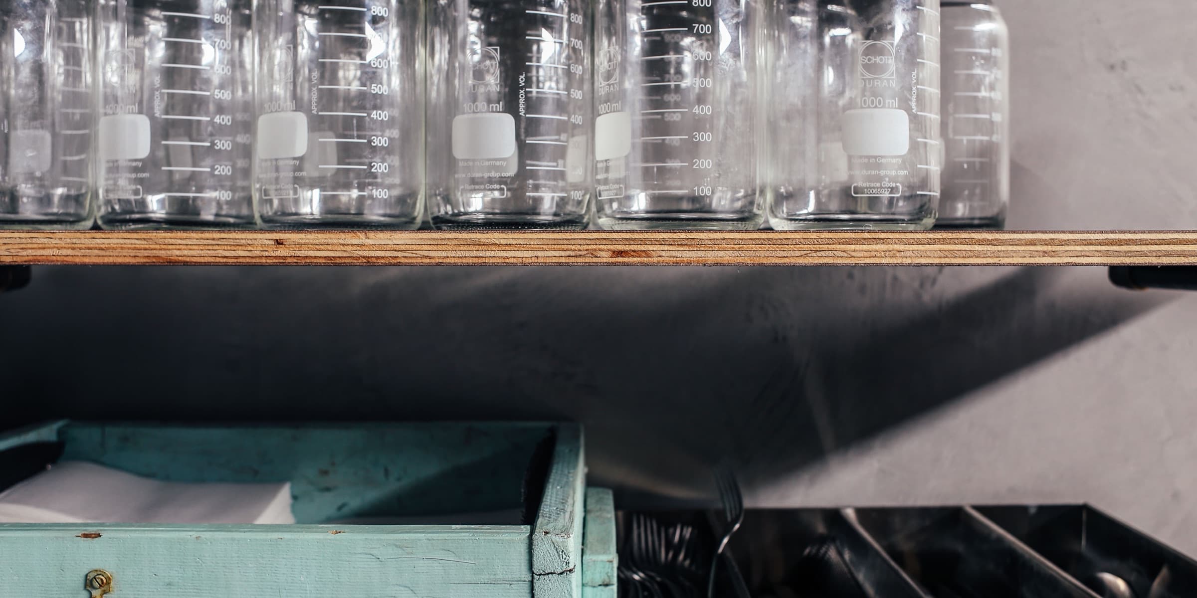 Rows of empty glass bottles on a shelf